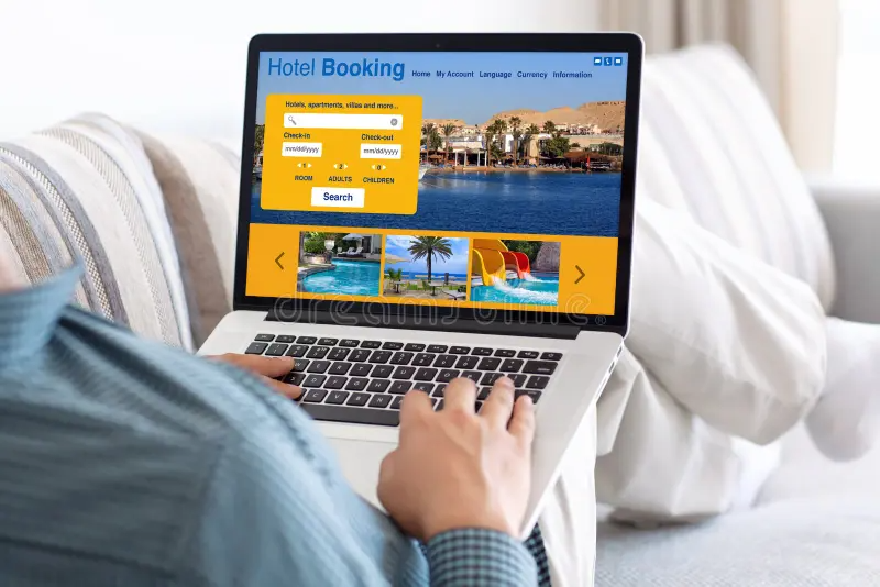 man-room-typing-laptop-keyboard-hotel-booking-screen-sofa-91923425